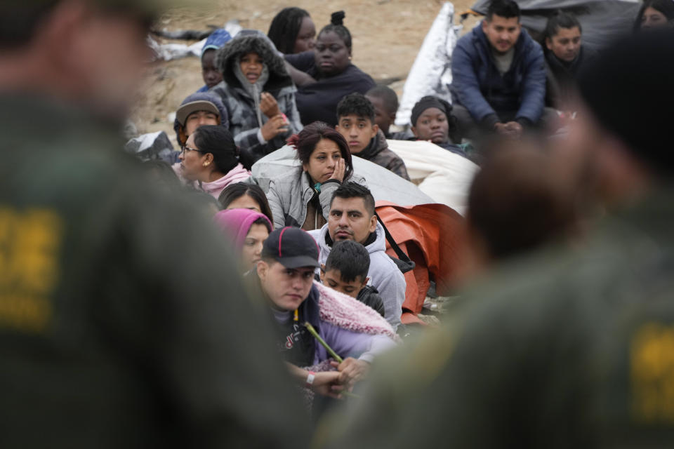 People line up as they wait to apply for asylum between two border walls, Friday, May 12, 2023, in San Diego. Hundreds of migrants remain waiting between the two walls, many for days. The U.S. entered a new immigration enforcement era Friday, ending a three-year-old asylum restriction and enacting a set of strict new rules that the Biden administration hopes will stabilize the U.S.-Mexico border and push migrants to apply for protections where they are, skipping the dangerous journey north. (AP Photo/Gregory Bull)