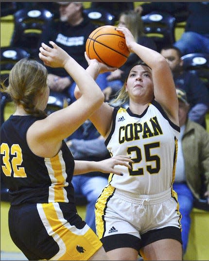 Rylee Vanschuyver, right, looks to fire a shot for Copan High during varsity girls action on Dec. 6, 2022, in Copan.