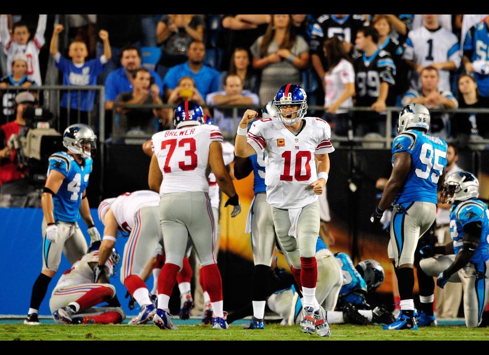 Eli Manning #10 of the New York Giants reacts after a touchdown against the Carolina Panthers during play at Bank of America Stadium on September 20, 2012 in Charlotte, North Carolina. 