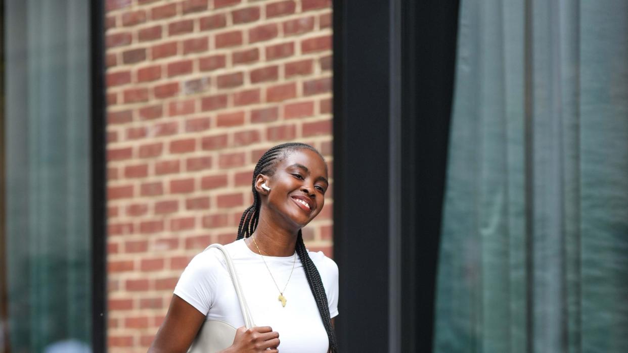 new york, new york september 09 a model wears a white cropped t shirt, blue cargo jeans pants, white sneakers shoes, a white bag, outside tibi , during new york fashion week, on september 09, 2023 in new york city photo by edward berthelotgetty images