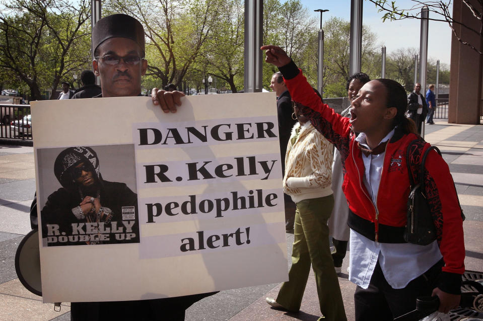 Dwight Taylor (L) of Gary Indiana is jeered by an R. Kelly supporter outside the Cook County courthouse where the R&B singer was due in court for the start of jury selection in his child pornography trial May 9, 2008 in Chicago, Illinois. Kelly has been accused of videotaping himself having sex with a girl believed to be as young as 13 years old. Kelly faces up to 15 years in prison if convicted.