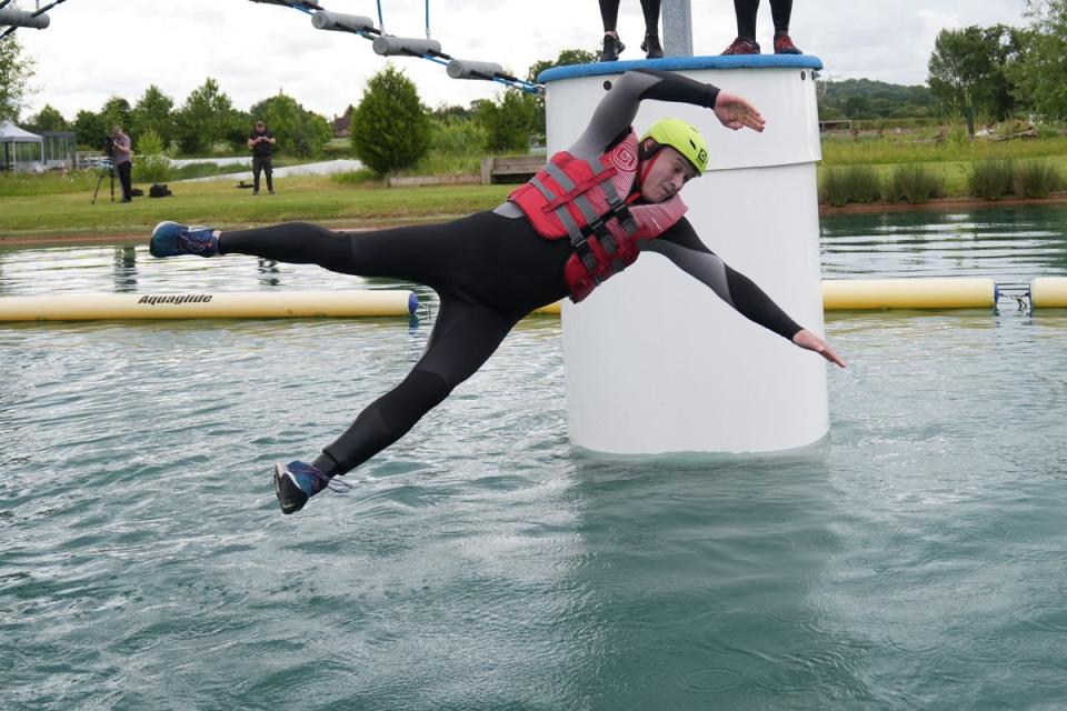 Liberal Democrats leader Sir Ed Davey falls as he attempts an Aqua Jungle floating assault course during a visit to Spot-On-Wake in Henley-in-Arden, Warwickshire (Jacob King/PA) (PA Wire)