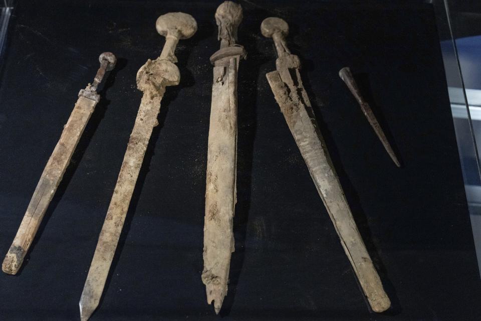 Israeli archaeologists show four Roman-era swords and a javelin head found during a recent excavation in a cave near the Dead Sea, in Jerusalem, Wednesday, Sep. 6, 2023. Archaeologists said the exceptionally preserved artifacts are dated to the 2nd century, when Jewish rebels launched an uprising against the Roman Empire. (AP Photo/Ohad Zwigenberg)