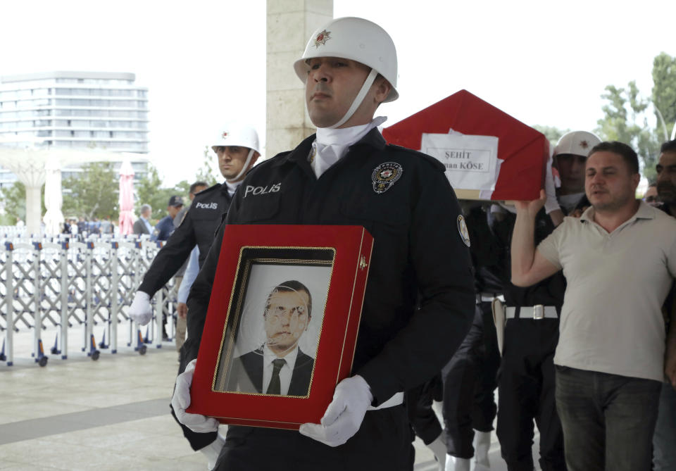 A police honour guard carry the coffin of Osman Kose, a 38-year-old Turkish diplomat killed in Iraq, before his funeral prayers in Ankara, Turkey, Thursday, July 18, 2019. A gunman opened fire inside a restaurant in the northern Iraqi city of Irbil on Wednesday, killing a Turkish diplomat working at Ankara's consulate, Turkey's state-run news agency and Iraqi media said.(AP Photo/Burhan Ozbilici)