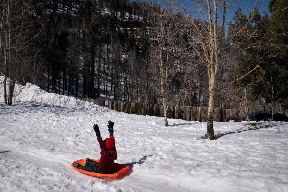 Jeremiah Reed, 5, of Tucson, sleds down a hill at Mount Lemmon Ski Valley.