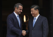 Greece's Prime Minister Kyriakos Mitsotakis, left, shakes hands with China's President Xi Jinping, right, prior to their meeting at Maximos Mansion in Athens, Monday, Nov. 11, 2019. Xi Jinping is in Greece on a two-day official visit. (AP Photos/Thanassis Stavrakis)