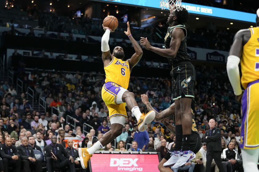 Los Angeles Lakers forward LeBron James shoots over Charlotte Hornets center Mark Williams.
