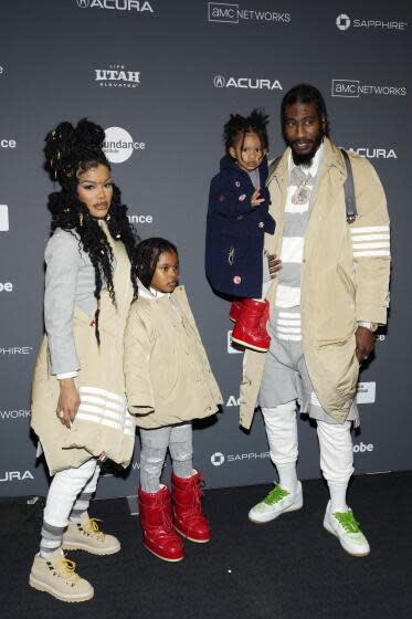 Teyana Taylor and Iman Shumpert and their two daughters pose together at a movie premiere