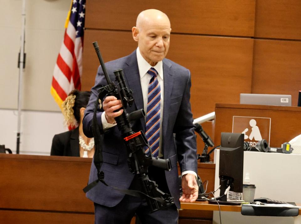 Assistant State Attorney Mike Satz checks into evidence the weapon used in Parkland's Marjory Stoneman Douglas High School shooting during the penalty phase of Nikolas Cruz at the Broward County Courthouse in Fort Lauderdale on Monday, July 25, 2022 (© South Florida Sun Sentinel 2022)