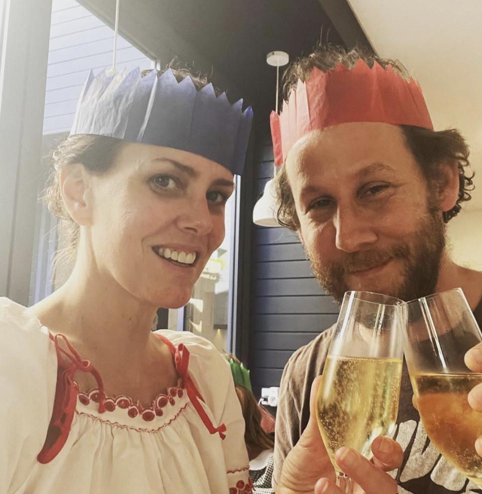 Ione Skye and her husband, musician Ben Lee wearing paper party crowns while enjoying Christmas Eve in Australia