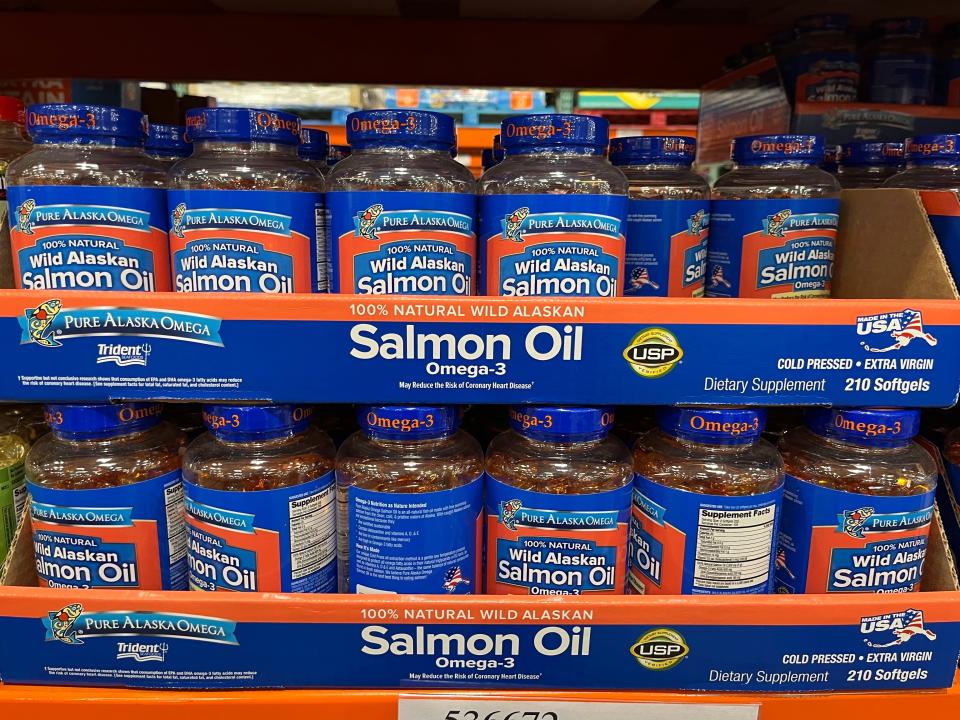 blue and orange packages of salmon oil on shelf at costco