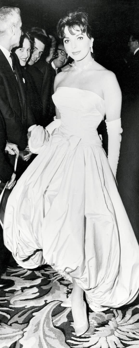 <p>Joan Collins clearly turned heads in this bubble hem gown—and in the '50s no formal look was complete without elbow-length gloves. </p>