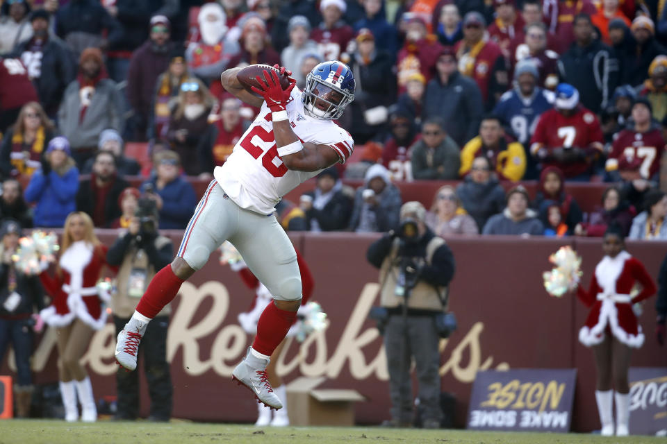 New York Giants running back Saquon Barkley catches a touchdown pass from quarterback Daniel Jones during the first half of an NFL football game against the Washington Redskins, Sunday, Dec. 22, 2019, in Landover, Md. (AP Photo/Alex Brandon)