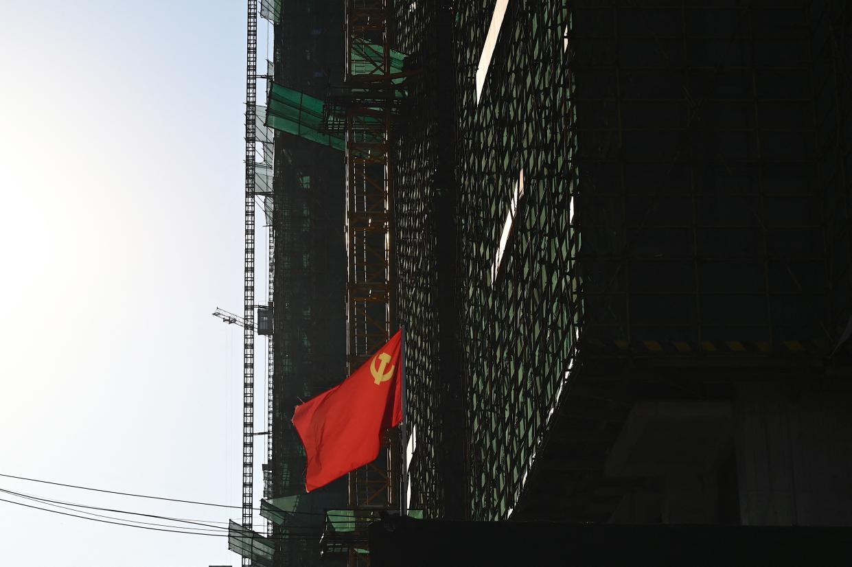 A communist party flag is seen at the construction site of an Evergrande housing complex in Zhumadian, central Chinas Henan province on September 14, 2021. (Photo by JADE GAO / AFP) (Photo by JADE GAO/AFP via Getty Images)