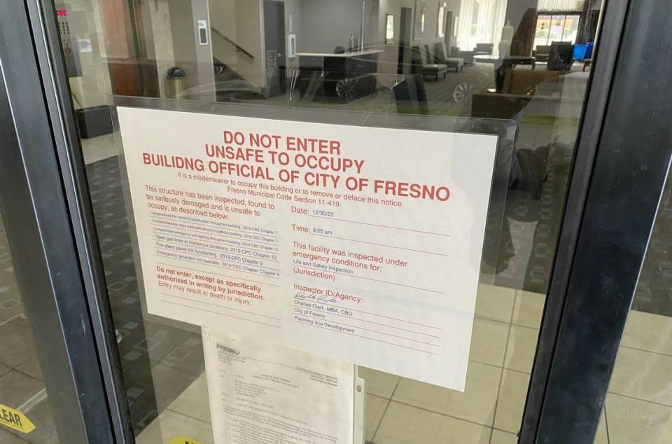 A sign on the door of the former Radisson Hotel on Van Ness Avenue in downtown Fresno declares the buiding closed because of fire and safety violations. New owners have purchased the building, but have not yet revealed specific plans for what it will be following its repair and renovation.