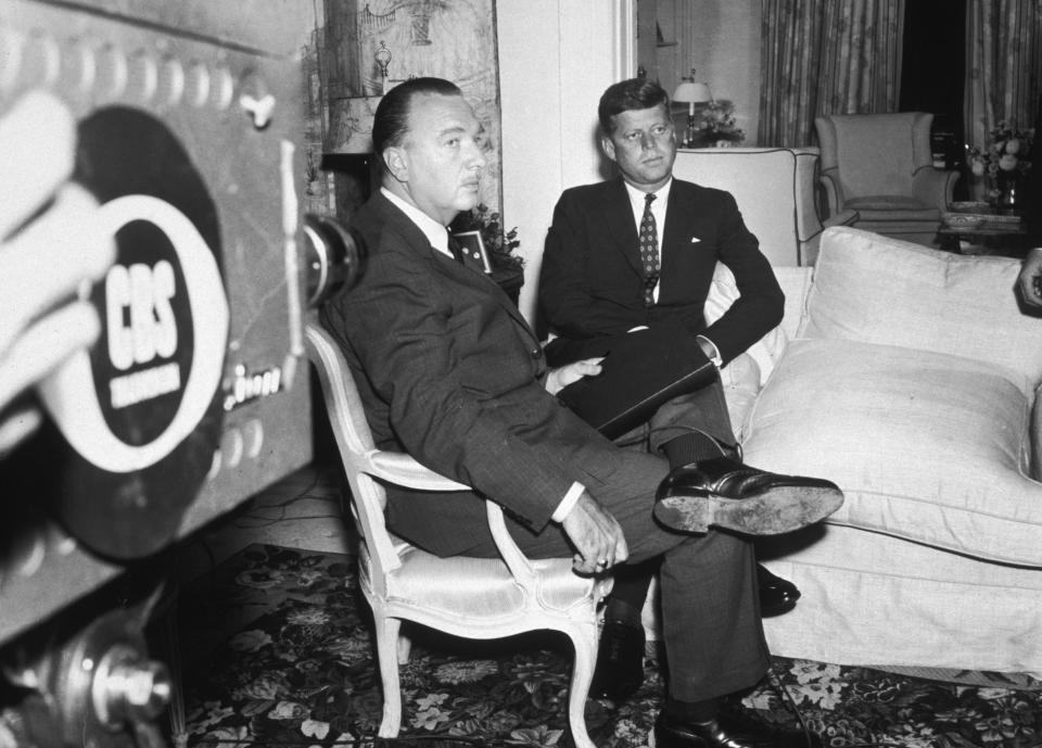Newscaster Walter Cronkite and President John F. Kennedy sit together during an interview for the premiere broadcast of the