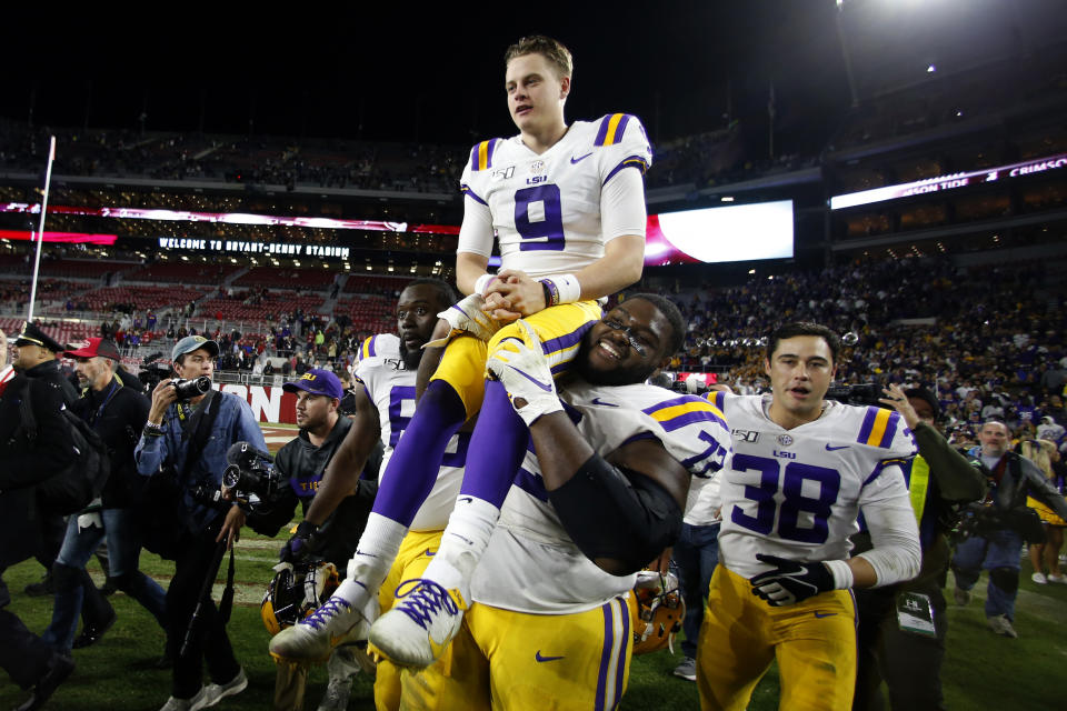 FILE - In this Nov. 10, 2019, file photo, LSU quarterback Joe Burrow (9) is carried by LSU nose tackle Tyler Shelvin (72) after an NCAA football game against Alabama, in Tuscaloosa, Ala. LSU quarterback Joe Burrow is The Associated Press college football player of the year in a landslide vote. Burrow, who has led the top-ranked Tigers to an unbeaten season and their first College Football Playoff appearance, received 50 of 53 first-place votes from AP Top 25 poll voters and a total of 156 points. (AP Photo/John Bazemore, File)