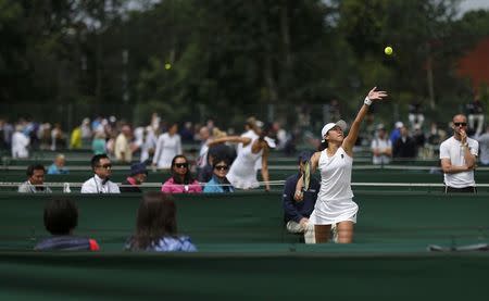 Japan's Junri Namigata serves the ball during her singles match against Spain's Sara Sorribes Tormo during the Wimbledon Tennis Championships qualifying rounds at the Bank of England Sports Centre in Roehampton, southwest London, Britain June 23, 2015. REUTERS/Suzanne Plunkett