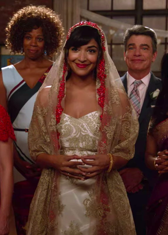 Cece wearing a strapless wedding dress and a veil