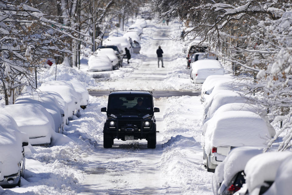 A snow-covered street in Denver on March 15, 2021.  / Credit: David Zalubowski / AP