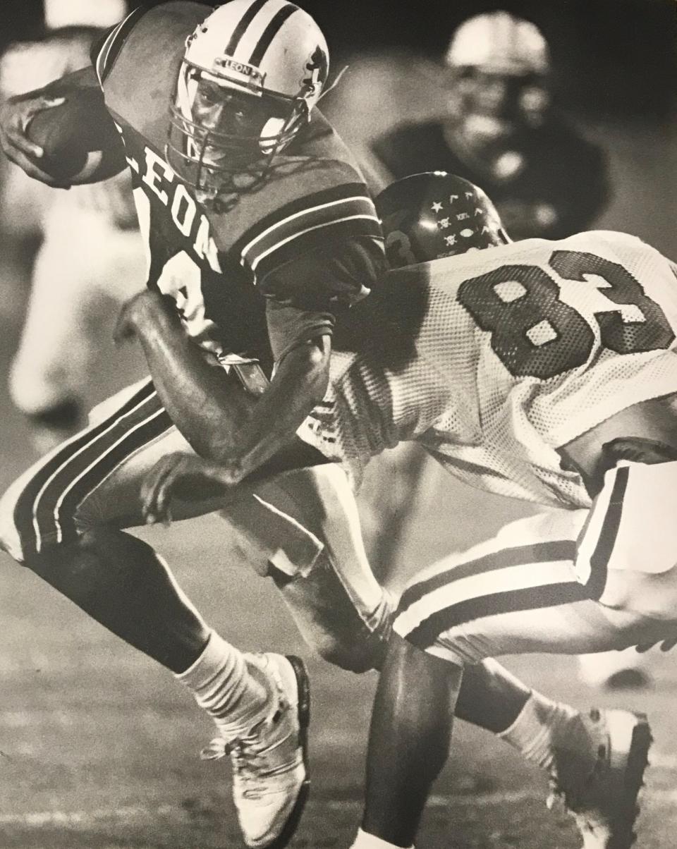 Leon's Tamarick Vanover turns upfield against a Panama City Bay defensive player in this photo from 1989.