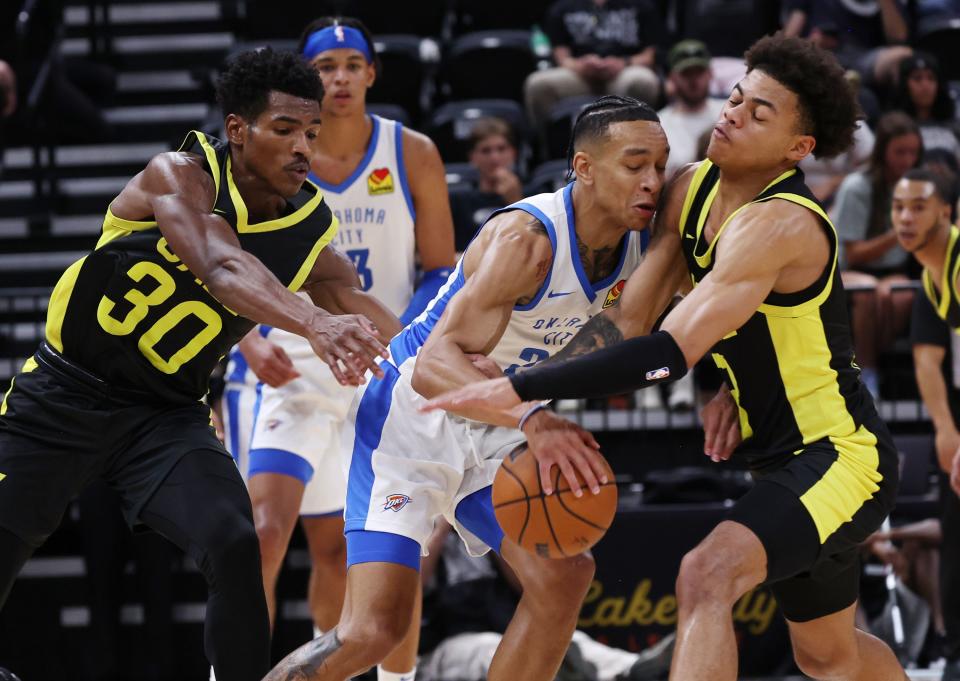 Utah Jazz players Ochai Agbaji and Keynote George try to gang up on Oklahoma City Thunder’s Tre Mann as they play in Summer League action at the Delta Center in Salt Lake City on Monday, July 3, 2023. Jazz lose 95-85. | Scott G Winterton, Deseret News