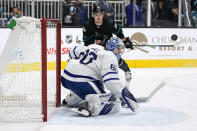 Toronto Maple Leafs goaltender Joseph Woll (60) blocks a shot by San Jose Sharks right wing Timo Meier, top, during the first period of an NHL hockey game Friday, Nov. 26, 2021, in San Jose, Calif. (AP Photo/Tony Avelar)