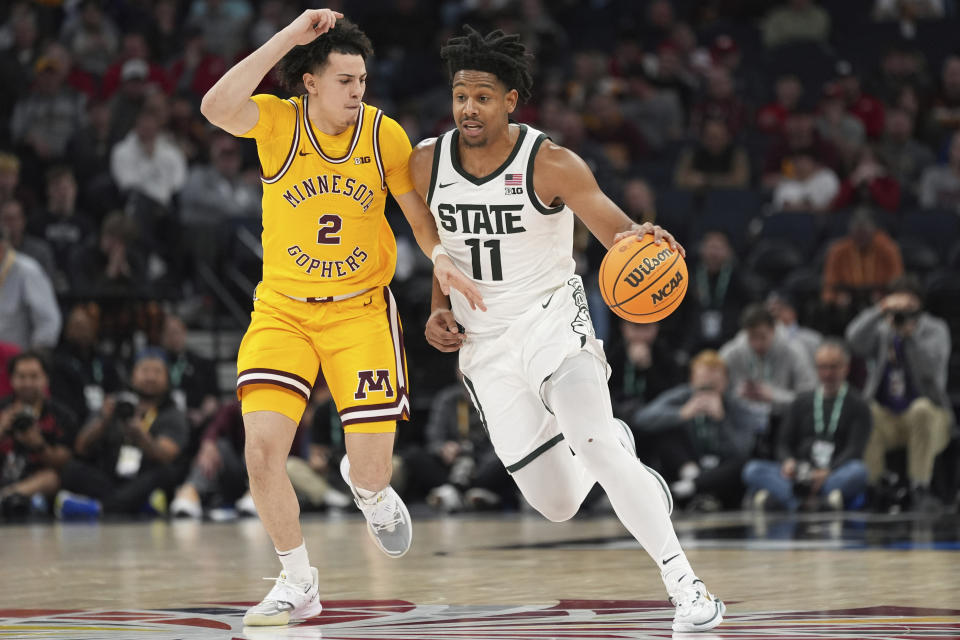 Michigan State guard A.J. Hoggard (11) works toward the basket as Minnesota guard Mike Mitchell Jr. (2) defends during the second half of an NCAA college basketball game in the second round of the Big Ten Conference tournament, Thursday, March 14, 2024, in Minneapolis. (AP Photo/Abbie Parr)