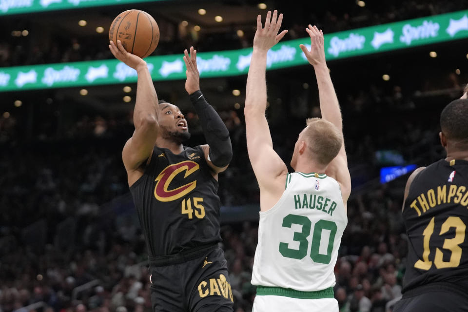 Cleveland Cavaliers guard Donovan Mitchell (45) shoots as Boston Celtics forward Sam Hauser (30) defends during the second half of Game 2 of an NBA basketball second-round playoff series Thursday, May 9, 2024, in Boston. (AP Photo/Steven Senne)