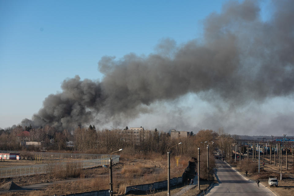 LVIV, UKRAINE - MARCH 18: Smoke is seen above buildings close to the airport on March 18, 2022 in Lviv, Ukraine. Lviv's mayor said on Telegram that the airport was not hit, but an area nearby. While Lviv, and western Ukraine more generally, has been a relative haven since Russia invaded Ukraine last month, there have been missile strikes across the region targeting airports and military sites. (Photo by Getty Images)