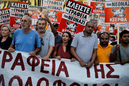 Protesters shout slogans and hold placards during a rally marking four years since the fatal stabbing of Greek anti-fascist rapper Pavlos Fyssas by a supporter of the ultranationalist Golden Dawn party in Athens, Greece, September 16, 2017. The placards read "Close down the offices of the neonazis". REUTERS/Alkis Konstantinidis