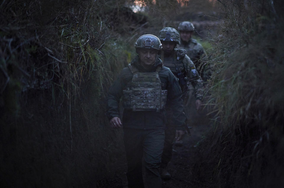 FILE - Ukrainian President Volodymyr Zelenskyy surrounded by servicemen as he visits the war-hit Donetsk region, eastern Ukraine, on Oct. 14, 2021. Ukrainian and Western officials are worried that a Russian military buildup near Ukraine could signal plans by Moscow to invade its ex-Soviet neighbor. The Kremlin insists it has no such intention and has accused Ukraine and its Western backers of making the claims to cover up their own allegedly aggressive designs. (Ukrainian Presidential Press Office via AP, File)