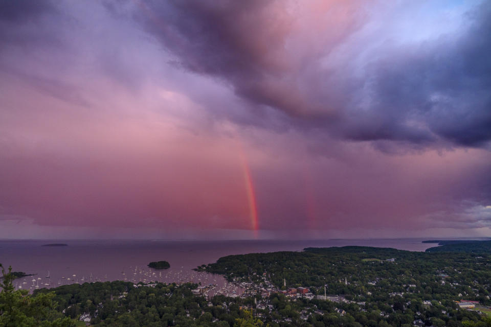 A rainstorm moves over the Atlantic Ocean after passing through Camden, Maine, at sunset, Tuesday, Aug. 1, 2023. (AP Photo/Robert F. Bukaty)