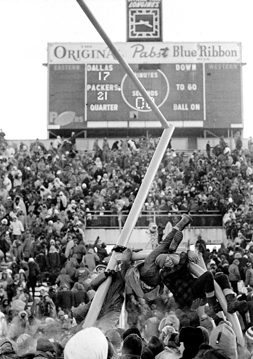 Fans climb on the goal post at Lanbeau Field in Green Bay, Dec. 31, 1967, after the Packers beat the Dallas Cowboys for the NFL Championship, 21-17. (AP Photo) ORG XMIT: APHS448505