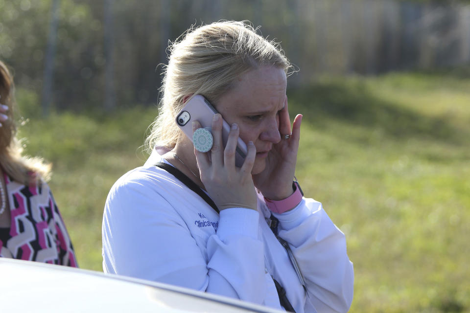 <p>A parent talks on cellphone waiting for news after a reports of a shooting at Marjory Stoneman Douglas High School in Parkland, Fla., on Feb. 14, 2018. (Photo: Joel Auerbach/AP) </p>