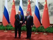 Russian Prime Minister Mikhail Mishustin and Chinese Premier Li Qiang attend a meeting in Beijing