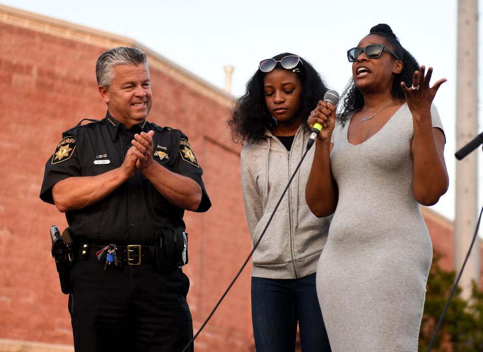 Wicomico County Sheriff's Deputy First Class Glenn Hilliard's wife and daughters attended his candlelight vigil Monday, June 13, 2022, in front of Perdue Stadium in Salisbury, Maryland.