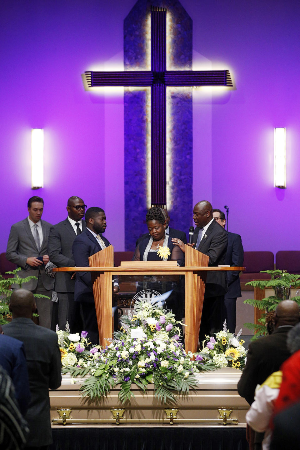 Leon Ochieng and Caroline Ouko, mother and older brother of Irvo Otieno, are seen with attorney Ben Crump during the celebration of life for Irvo Otieno at First Baptist Church in North Chesterfield, Va., on Wednesday, March 29, 2023. Irvo Otieno, a 28-year-old Black man, died after he was pinned to the floor by seven sheriff's deputies and several others while he was being admitted to a mental hospital. (Eva Russo/Richmond Times-Dispatch via AP)