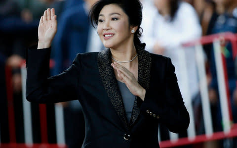 Former Thai prime minister Yingluck Shinawatra waves to supporters as she arrives to deliver closing statements in her trial at the Supreme Court's Criminal Division  - Credit: Rungfoj Yongrit/EPA