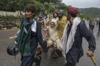 Supporters of Tahir ul-Qadri, a Sufi cleric and leader of Pakistan Awami Tehreek (PAT) party, help a fellow supporter who is injured, during the Revolution March in Islamabad September 1, 2014. REUTERS/Zohra Bensemra