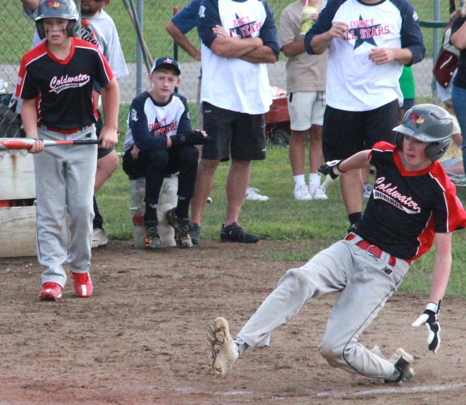 Coldwater's Will Knowlon slides safely home for the final run of the game for the Redbirds in their tough loss to Quincy Tuesday