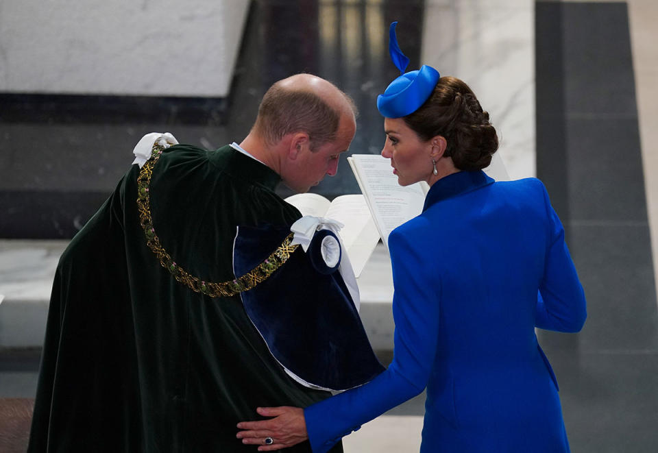 Kate Middleton was snapped gently patting Prince William. Photo: AAP