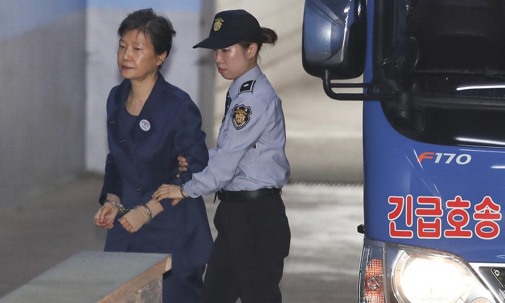 Park Geun-hye arrives in handcuffs for her trial in Seoul on Monday.