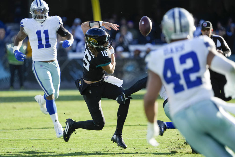 Jacksonville Jaguars quarterback Trevor Lawrence (16) fumbles the ball during the second half of an NFL football game against Dallas Cowboys, Sunday, Dec. 18, 2022, in Jacksonville, Fla. (AP Photo/John Raoux)