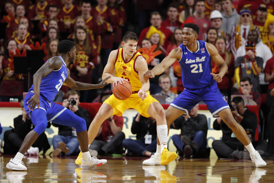 Iowa State forward Michael Jacobson, center, battles Seton Hall guard Myles Cale, left, and Seton Hall center Ike Obiagu, right, to get to the basket during the first half of an NCAA college basketball game, Sunday, Dec. 8, 2019, in Ames, Iowa. (AP Photo/Matthew Putney)