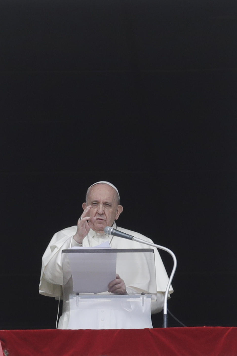 Pope Francis delivers his blessing as he recites the Regina Caeli noon prayer from the window of his studio overlooking St.Peter's Square, at the Vatican, Sunday, April 18, 2021. Pope Francis said he is happy to be back greeting the faithful in St. Peter’s Square faithful for his traditional Sunday noon blessing after weeks of lockdown measures. (AP Photo/Andrew Medichini)