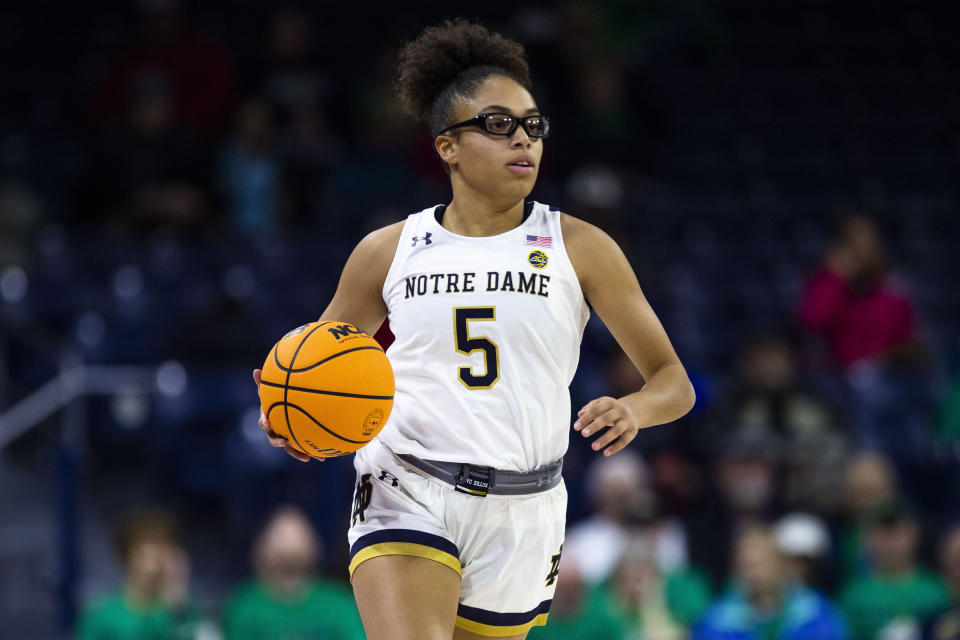 Notre Dame&#39;s Olivia Miles takes the ball up the court against Merrimack on Dec. 10, 2022 in South Bend, Indiana. (AP Photo/Michael Caterina)