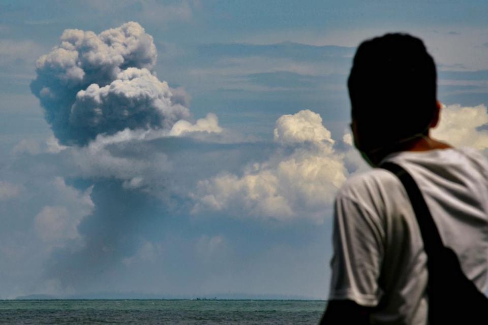 Man watches Krakatau spewing ash during an eruption on Saturday: Getty