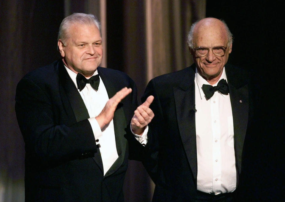 FILE - In this June 6, 1999 file photo, actor Brian Dennehy, left, applauds playwright, Arthur Miller, before awarding him the Lifetime Achievement Award at the Tony Awards in New York. Dennehy, the burly actor who started in films and later in his career won plaudits for his stage work in plays, died of natural causes on Wednesday, April 15, 2020 in New Haven, Conn. He was 81.  (AP Photo/Kathy Willens, File)