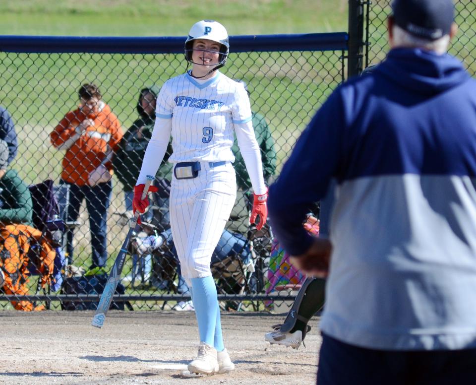 Petoskey's Brooke Bixby smiles down to head coach Dave Serafini during an at-bat in game one against Alpena.